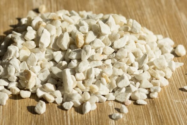 Heap Of Zeolite Stone On Wooden Background ZEOLITA - SACO 1KG